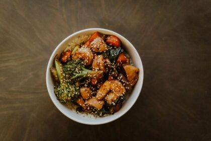 A great stir-fry is more than a combination of vegetables, protein, and noodles or rice—it’s the sauce that ties everything together. While grocery store shelves are filled with bottled options, making your own sauce at home gives you complete control over flavor, sweetness, saltiness, and spice. Better yet, you probably already have most of the ingredients sitting in your pantry. Learning how to create a homemade stir-fry sauce doesn't require professional cooking skills or a long list of specialty ingredients. By understanding a few basic flavor principles, you can mix and match everyday staples to create sauces that complement everything from chicken and beef to tofu and fresh vegetables. Once you know the fundamentals, you'll rarely need to rely on store-bought alternatives again. Why Homemade Sauces Are Worth the Effort Preparing your own sauce allows you to customize every aspect of the recipe. If you prefer a sweeter finish, you can add a little extra honey or brown sugar. If you enjoy bold, savory flavors, you can increase the soy sauce or garlic. You can even adjust the thickness to suit whether you're serving the meal over rice, noodles, or vegetables. Another advantage is freshness. Homemade sauces often contain fewer preservatives and unnecessary additives than many bottled varieties. They're also an excellent way to use pantry ingredients you already keep on hand, making weeknight meals both affordable and convenient. With just a few staple ingredients, you can prepare a flavorful stir fry sauce that works with countless recipes, eliminating the guesswork whenever you're craving a quick homemade dinner. The Five Essential Flavor Components Most successful stir-fry sauces are built by balancing five key elements. Understanding these building blocks makes it much easier to experiment confidently. 1. Salty The salty component creates the foundation of the sauce. Common choices include: Soy sauce Low-sodium soy sauce Tamari Coconut aminos These ingredients provide depth while enhancing the natural flavors of the food. 2. Sweet A touch of sweetness balances salty and savory flavors. Popular options include: Honey Brown sugar Maple syrup White sugar Only a small amount is usually needed to create a well-rounded sauce. 3. Acid Acidity brightens the overall flavor and prevents the sauce from tasting heavy. Good pantry choices include: Rice vinegar Apple cider vinegar Fresh lemon juice Fresh lime juice Even a teaspoon or two can make a noticeable difference. 4. Aromatics Garlic and ginger are classic additions that add warmth and complexity. Fresh ingredients often provide the strongest flavor, but garlic powder and ground ginger can work well when you're short on time. Other flavorful additions include: Onion powder Shallots Scallions Sesame oil 5. Thickener A quality stir-fry sauce lightly coats the ingredients rather than pooling at the bottom of the pan. Cornstarch mixed with cold water creates a simple slurry that thickens the sauce during cooking. Arrowroot powder is another excellent alternative. A Simple Homemade Stir-Fry Sauce Recipe Once you understand the basic flavor balance, creating your own sauce becomes incredibly simple. Ingredients ¼ cup low-sodium soy sauce 2 tablespoons honey 1 tablespoon rice vinegar 2 cloves garlic, minced 1 teaspoon grated fresh ginger 1 teaspoon sesame oil 1 tablespoon cornstarch 2 tablespoons cold water Instructions Whisk together the soy sauce, honey, rice vinegar, garlic, ginger, and sesame oil. In a separate small bowl, combine the cornstarch and cold water until smooth. Stir the slurry into the sauce mixture. Pour the sauce into a hot skillet or wok during the final few minutes of cooking your vegetables and protein. Stir continuously until the sauce thickens and evenly coats the ingredients. The result is a balanced sauce that works beautifully with chicken, beef, shrimp, tofu, or mixed vegetables. Easy Ways to Customize the Flavor One of the biggest advantages of homemade sauces is their flexibility. For More Heat Add one or more of the following: Sriracha Chili garlic sauce Crushed red pepper flakes Fresh sliced chilies For Extra Sweetness Try: Additional honey Brown sugar Pineapple juice Orange juice For More Umami Boost savory flavor with: Oyster sauce Mushroom powder Hoisin sauce Worcestershire sauce For Nutty Flavor A small amount of toasted sesame oil or natural peanut butter adds richness without overwhelming the dish. Pantry Staples Worth Keeping Stocking a few versatile ingredients makes homemade stir-fry meals much easier. Consider keeping: Soy sauce Rice vinegar Sesame oil Cornstarch Honey Brown sugar Garlic Ginger Black pepper Red pepper flakes With these basics available, you'll always have the foundation for a delicious homemade sauce. Common Mistakes to Avoid Even simple sauces can be improved by avoiding a few common errors. Adding Too Much Soy Sauce Excess soy sauce can quickly overpower the dish. Taste as you go and adjust gradually. Forgetting the Thickener Without cornstarch or another thickener, the sauce may remain watery instead of clinging to the ingredients. Using High Heat Too Early Cooking garlic over excessively high heat may cause it to burn and develop bitterness. Skipping the Taste Test Before adding the sauce to your stir-fry, taste it. Small adjustments are much easier before cooking than afterward. Best Foods to Pair with Homemade Stir-Fry Sauce A versatile homemade sauce works with a wide variety of ingredients. Popular proteins include: Chicken breast Beef strips Shrimp Pork Tofu Favorite vegetables include: Broccoli Bell peppers Snap peas Mushrooms Carrots Bok choy Zucchini Complete the meal with steamed jasmine rice, brown rice, rice noodles, or lo mein noodles for a satisfying dinner. Make-Ahead Tips Homemade stir-fry sauce is ideal for meal preparation. Mix the ingredients in advance and store the sauce in an airtight jar in the refrigerator for up to one week. Shake well before using, as the cornstarch may settle over time. Preparing the sauce ahead of time allows you to create fresh stir-fry dinners in just minutes, making busy weeknights much less stressful. Final Thoughts Learning how to build the perfect stir-fry sauce from everyday pantry ingredients is one of the most useful kitchen skills you can develop. Rather than relying on bottled sauces, you can create fresh, customizable flavors that perfectly match your personal preferences and the ingredients you have on hand. By understanding the balance of salty, sweet, acidic, aromatic, and thickening elements, you'll be able to create countless variations without following a recipe every time. Whether you're preparing a quick vegetable stir-fry, a hearty chicken dinner, or a flavorful noodle bowl, a homemade sauce adds freshness and depth that transforms simple ingredients into a meal you'll want to make again and again.